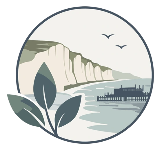 The Sussex Cove Gardening Company emblem: chalk cliffs above a curving beach, the pier out on the sea, and leaves in the foreground